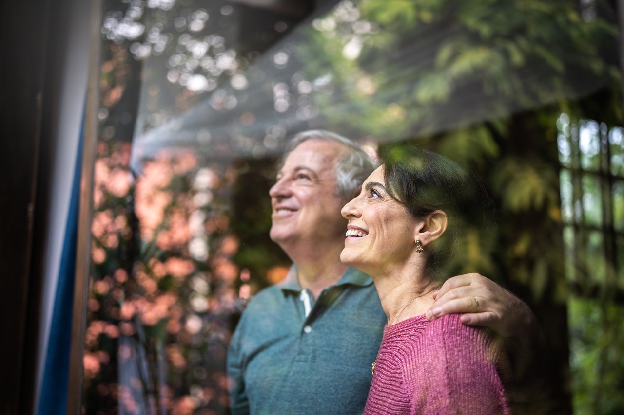 Couple Looking Senior couple looking through window