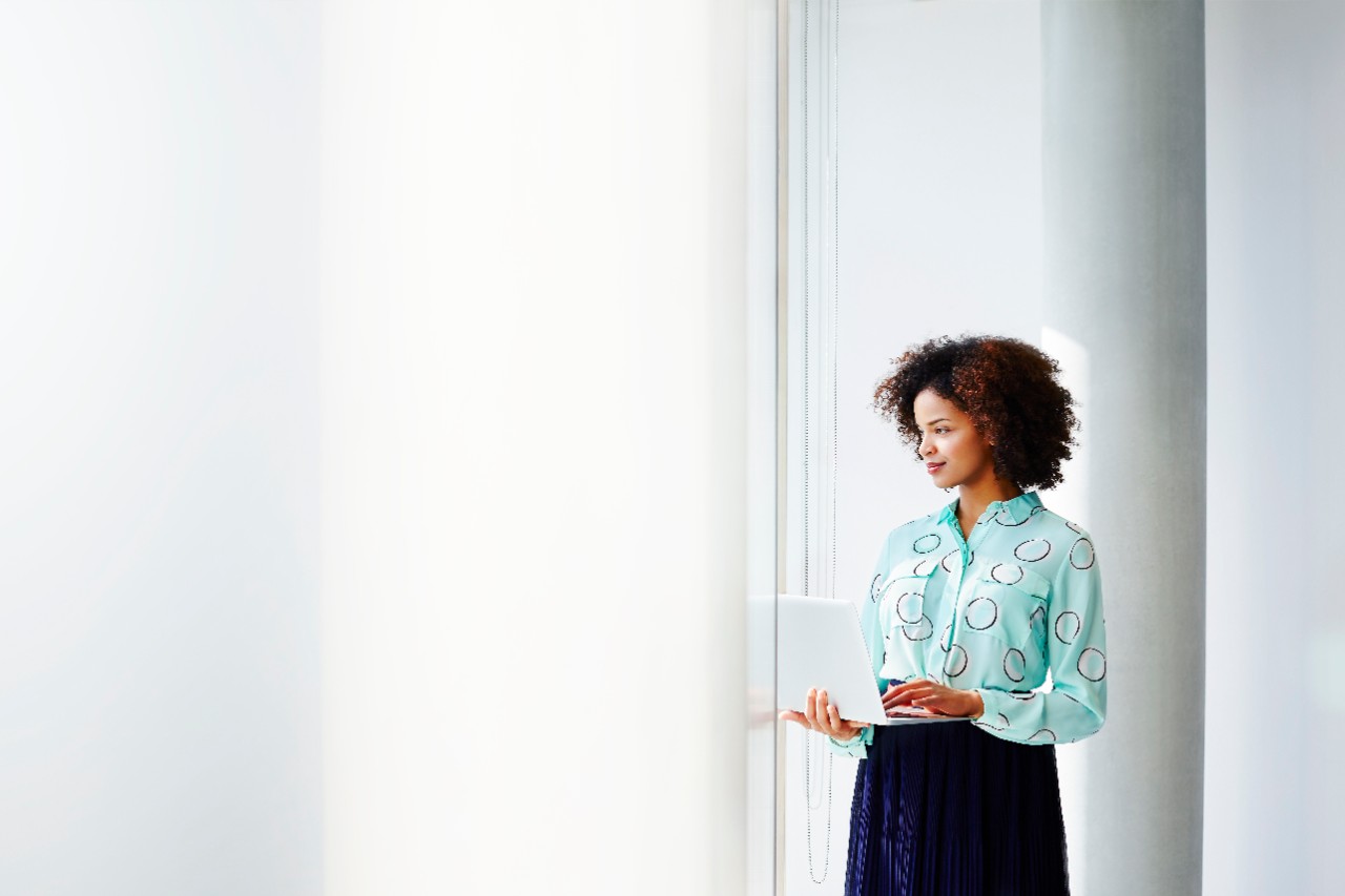 a woman looking through a window at the office
