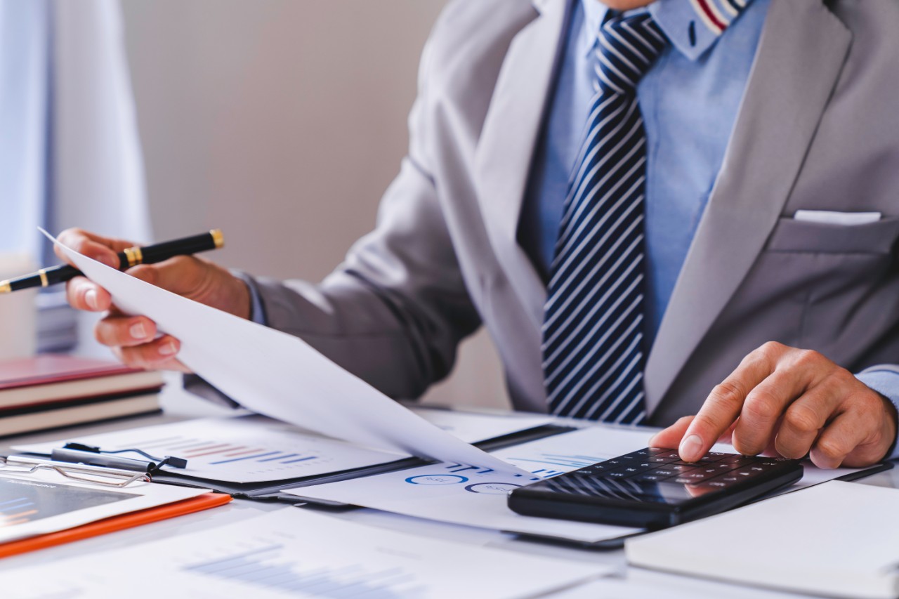 Man showing information on a sheet to a couple